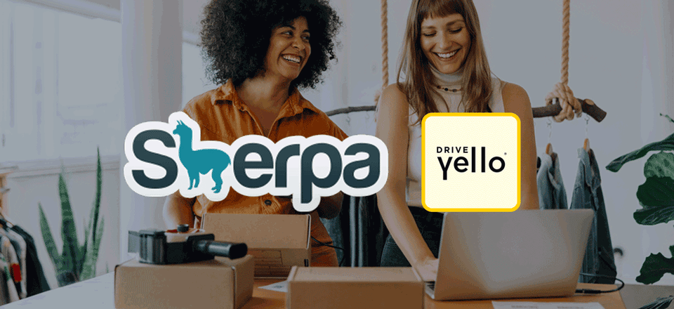 Two women in a clothing store with laptop, scanning packages for delivery with the Sherpa and Drive Yello logos merging into one Sherpa logo